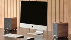 Ruark MR1 Mk3 bluetooth speakers on either side of an iMac