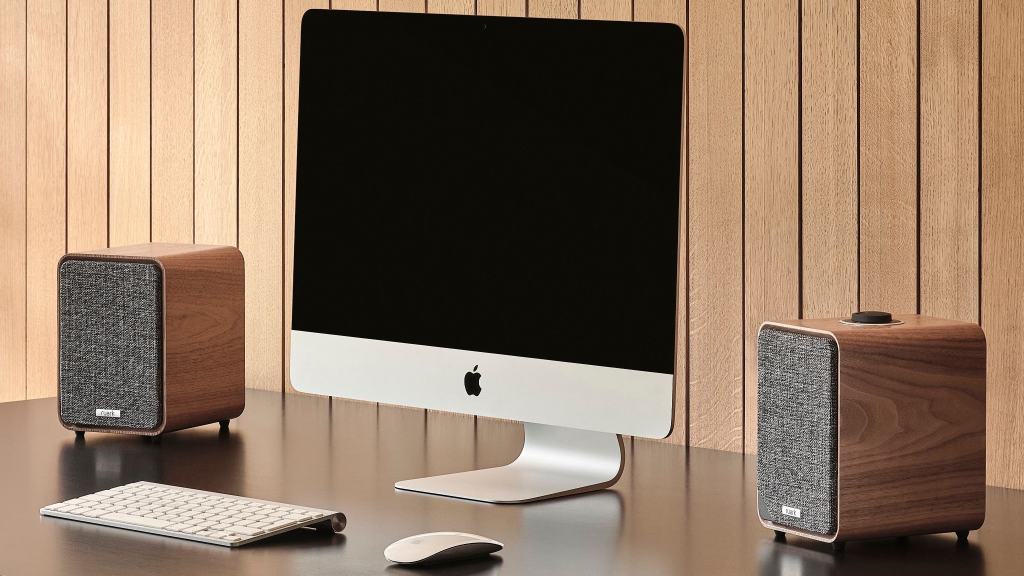 Ruark MR1 Mk3 bluetooth speakers on either side of an iMac