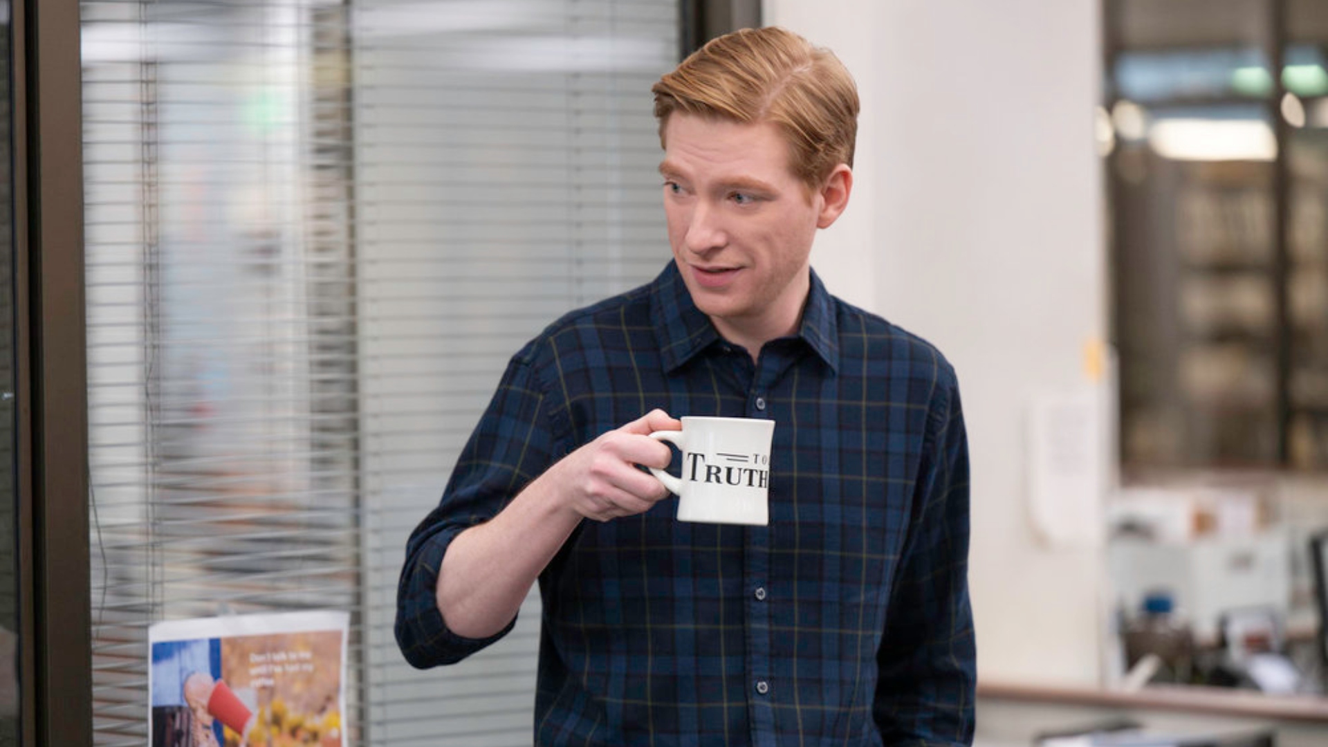 Ned holds a mug in The Paper season 1