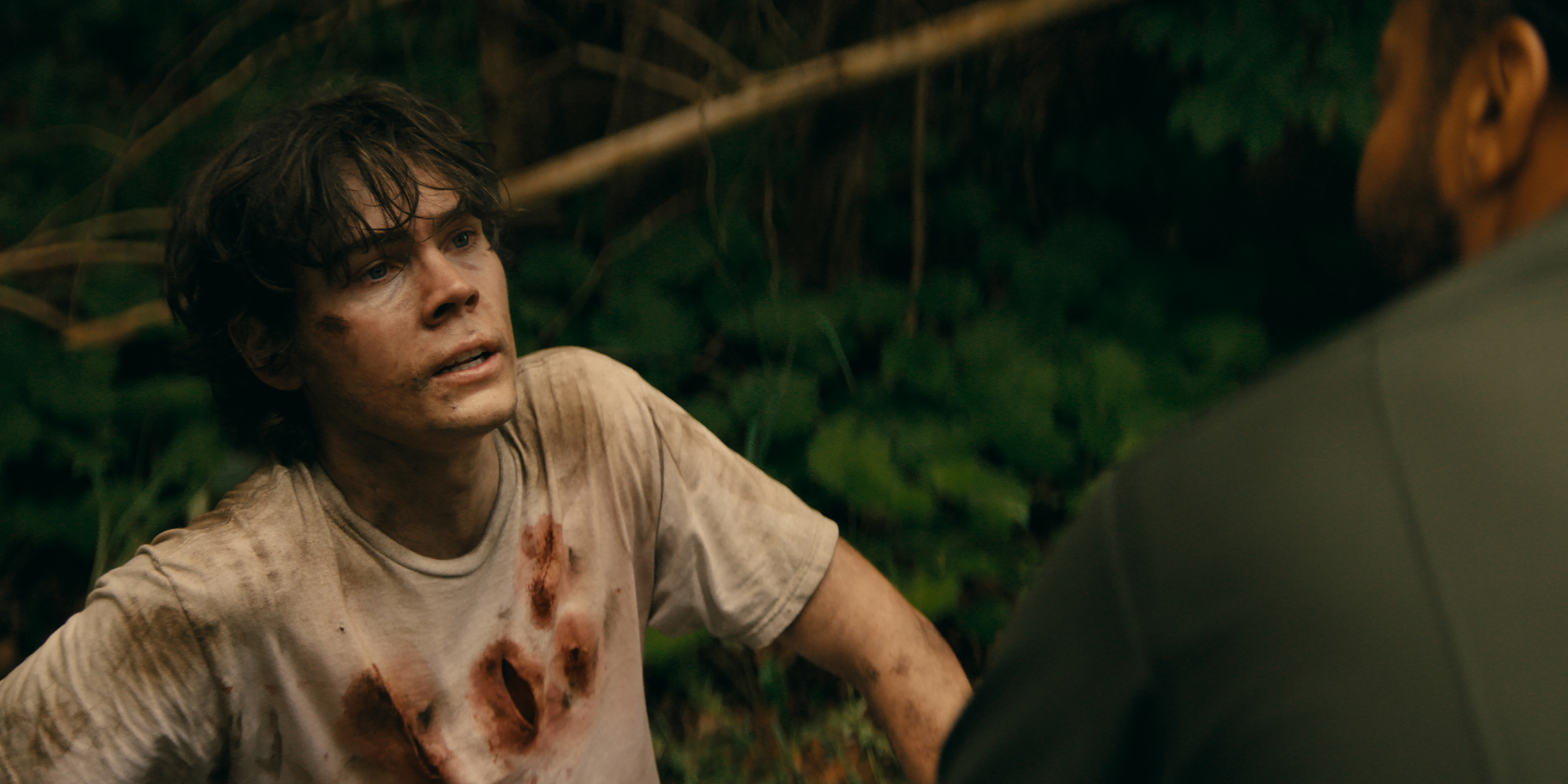 Gage Monroe as Riley in a bloody tshirt in the woods in wayward