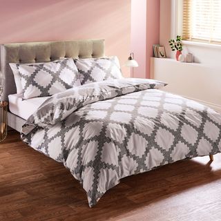 bedroom with monochrome geometric trellis pattern bedding set and pair of pillowcase