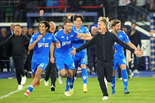 Empoli players and coach Davide Nicola celebrate after the team's last-gasp win over Roma secures Serie A survival in May 2024.