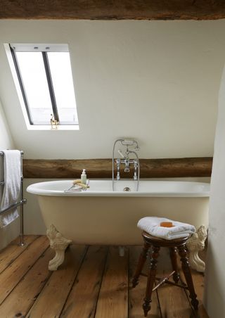 period bath in a bathroom with silver brassware and wooden detailing