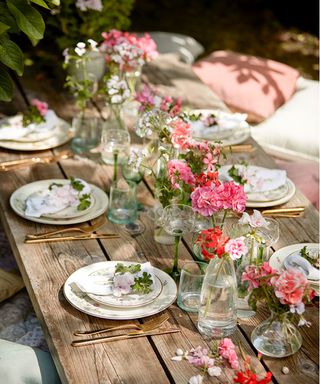 Outdoor birthday party ideas with wooden table and flowers