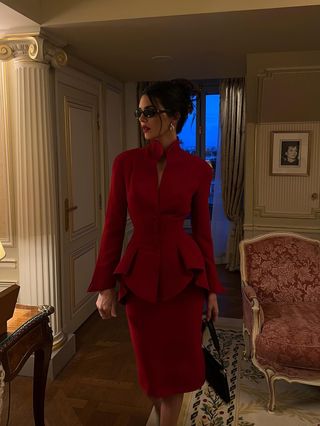 Kendall Jenner in Paris wearing a red skirt suit and Gucci sunglasses.