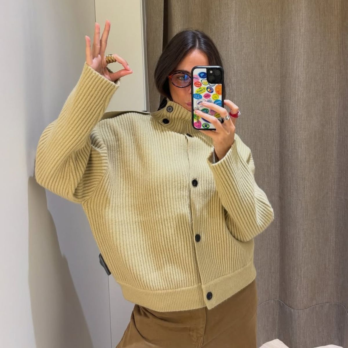 Woman wears mustard massimo dutti funnel neck button cardigan 