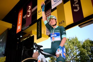 Charlotte Kool starting stage six of the Tour de France Femmes 2024 in a green skinsuit