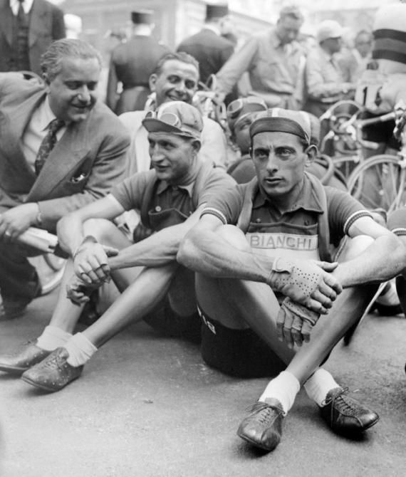 Picture taken in July 1949 of Italian cyclists Gino Bartali (L) and Fausto Coppi (R) waiting before the start of a stage of the Tour de France. The two champions won 2 Tour de France each : Bartali in 1938 and 1948, Coppi in 1949 and 1952.