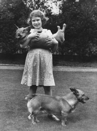 Princess Elizabeth (now Queen Elizabeth II) with two corgi dogs at her home at 145 Piccadilly, London, July 1936. (Photo by Lisa Sheridan/Studio Lisa/Hulton Archive/Getty Images)
