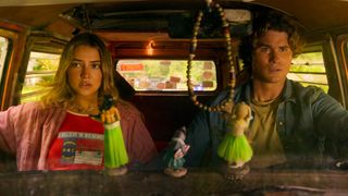 Madelyn Cline as Sarah and Chase Stokes as John B. sitting in their van.