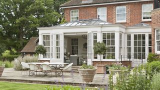cream timber conservatory with sash windows and patio doors