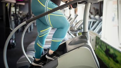 Woman completes a Stairmaster workout at a gym