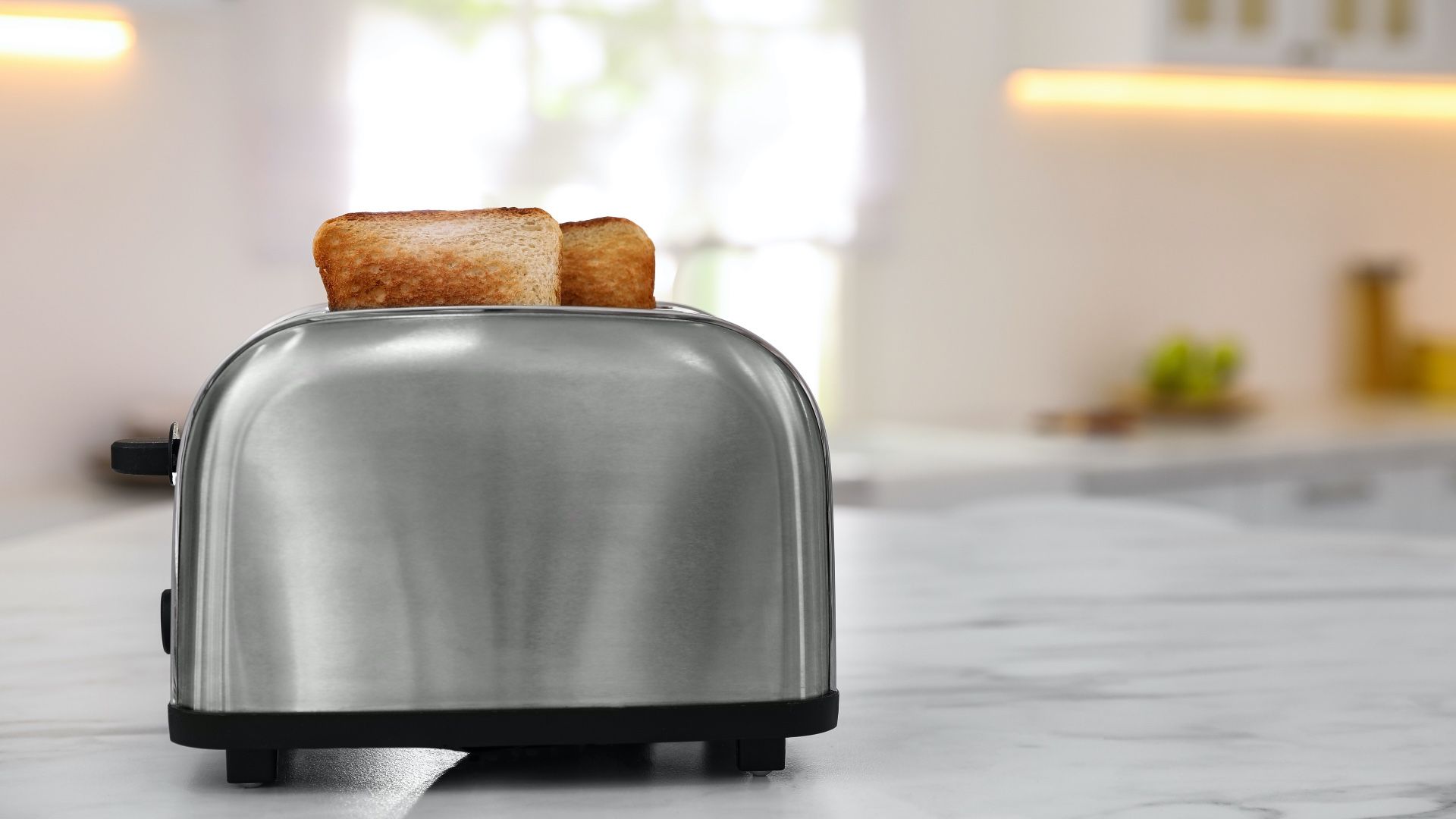 toaster with bread inside it on a white kitchen surface