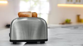 toaster with bread inside it on a white kitchen surface
