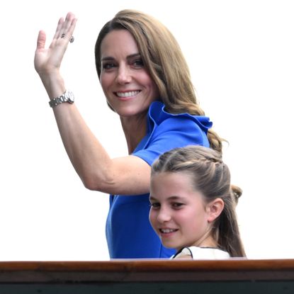 Princess Kate waves while wearing a royal blue dress while daughter Princess Charlotte wears white
