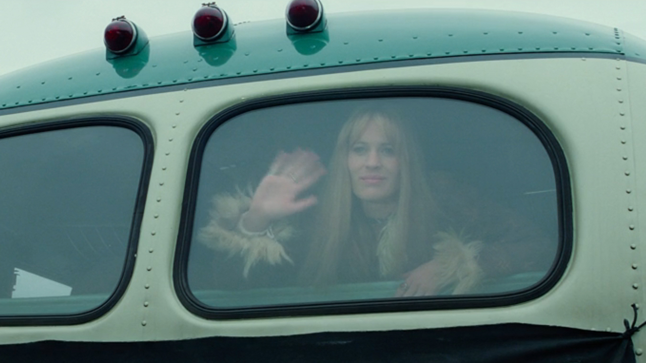 Robin wright waving goodbye from the back of a bus in Forrest Gump