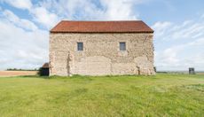 A side view of the Saxon chapel of Saint Peter-on-the-Wall at Bradwell-on-Sea, Essex on the Dengie Peninsula. It is one of the oldest Christian churches still in regular use in England. The church was founded by Saint Cedd in 654 AD on the foundations of an abandoned Roman fort. It was restored as a chapel in the 1920's.