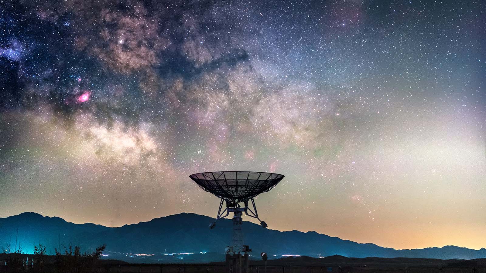The Milky Way is seen above a radio telescope.