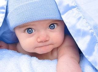 cute baby boy under blue blanket