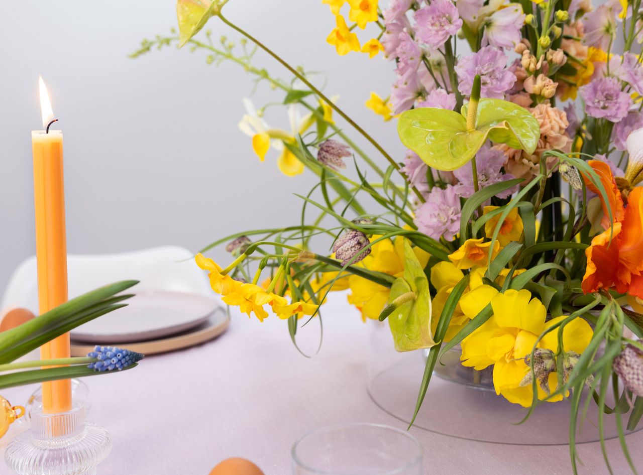 a vase of flowers including narcissus and tulips