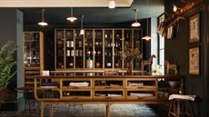 Extensive pantry feature in moody kitchen with mid-century touches