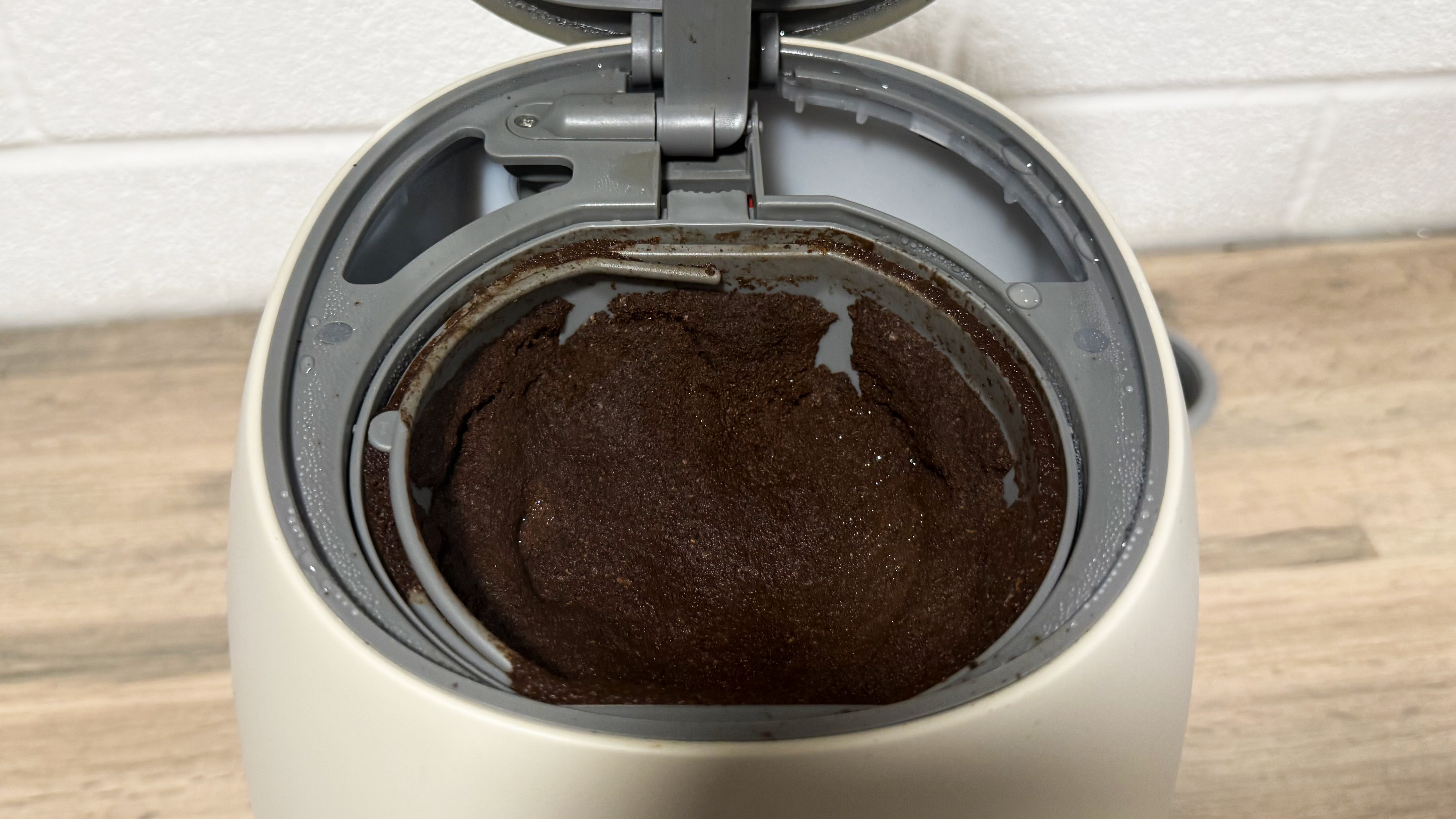 a photo of the smeg retro coffee maker after brewing showing coffee grounds