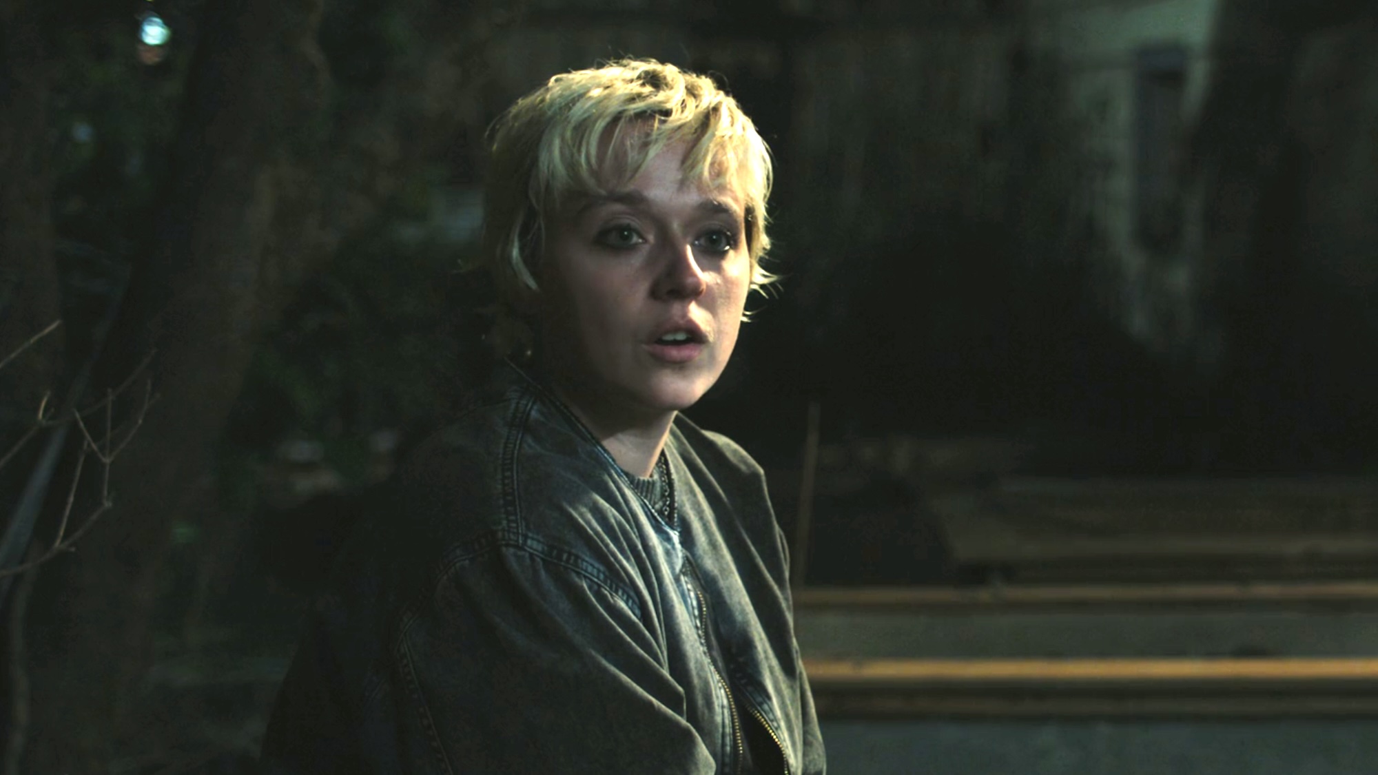 Emaline talking to Carrie in her backyard at night.