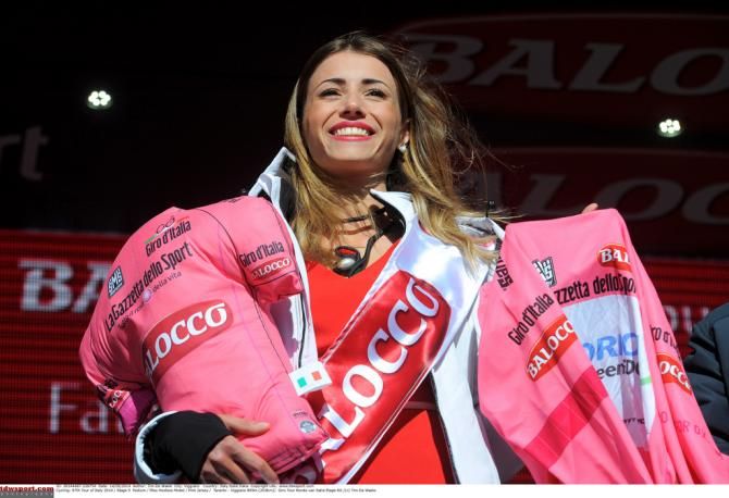 The podium hostess with the prizes for the maglia rosa