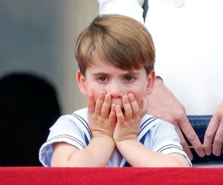 Prince Louis balcony: hands over mouth