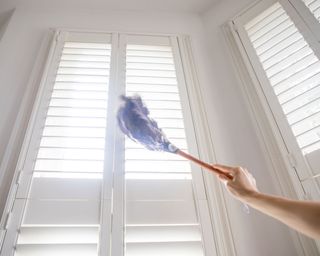 venetian blinds being dusted