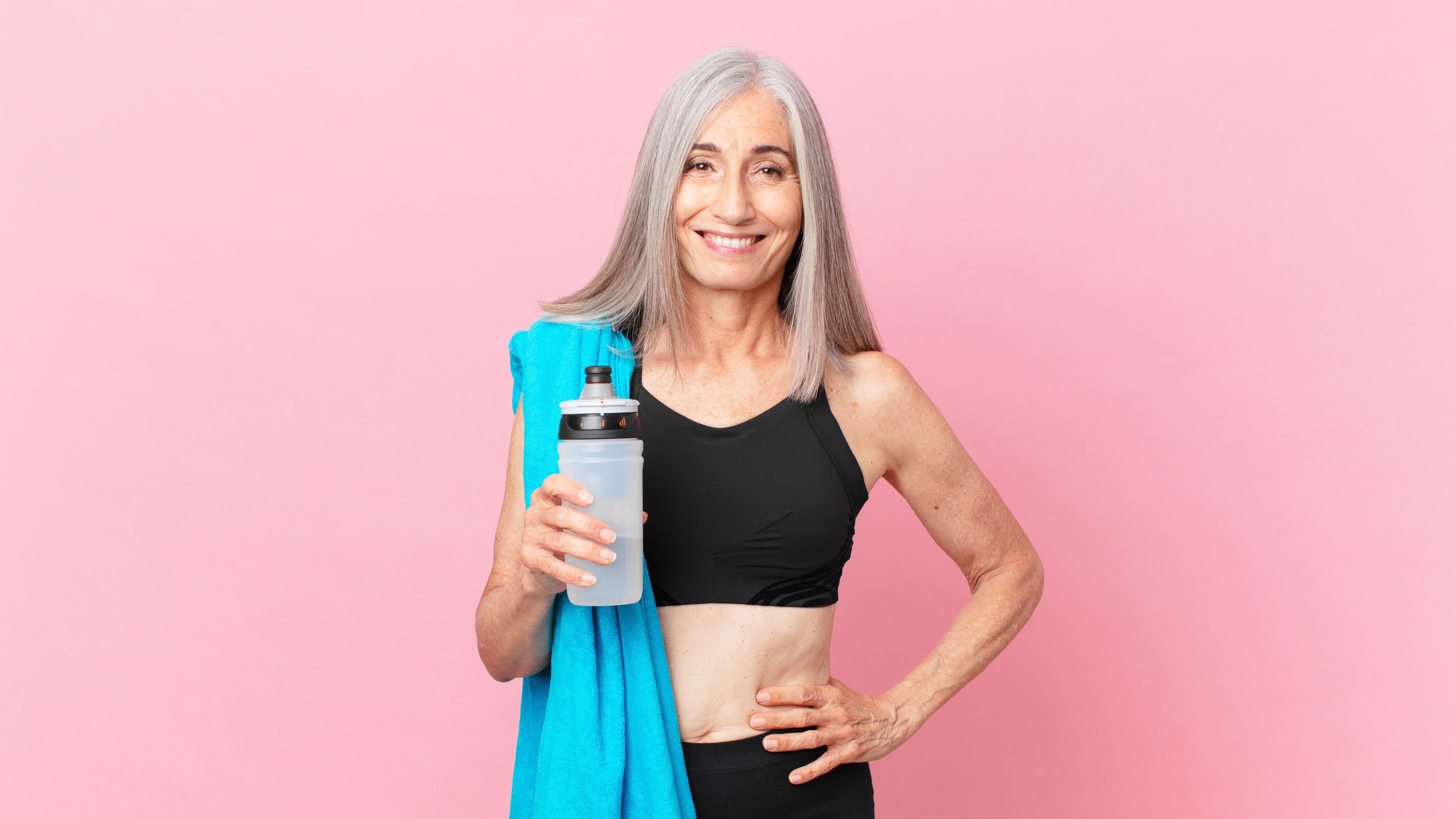 a middle aged woman holding a water bottle 