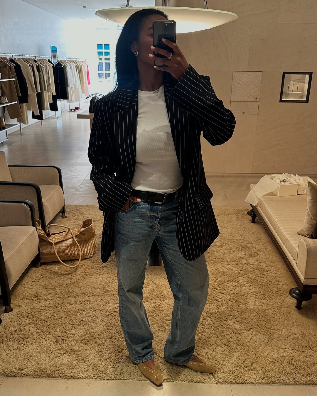 influencer wearing a white T shirt and jeans