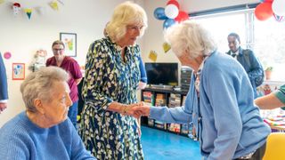 Queen Camilla speaks with patients as she visits NHS Lothian's Medicine of the Elderly Meaningful Activity Centre