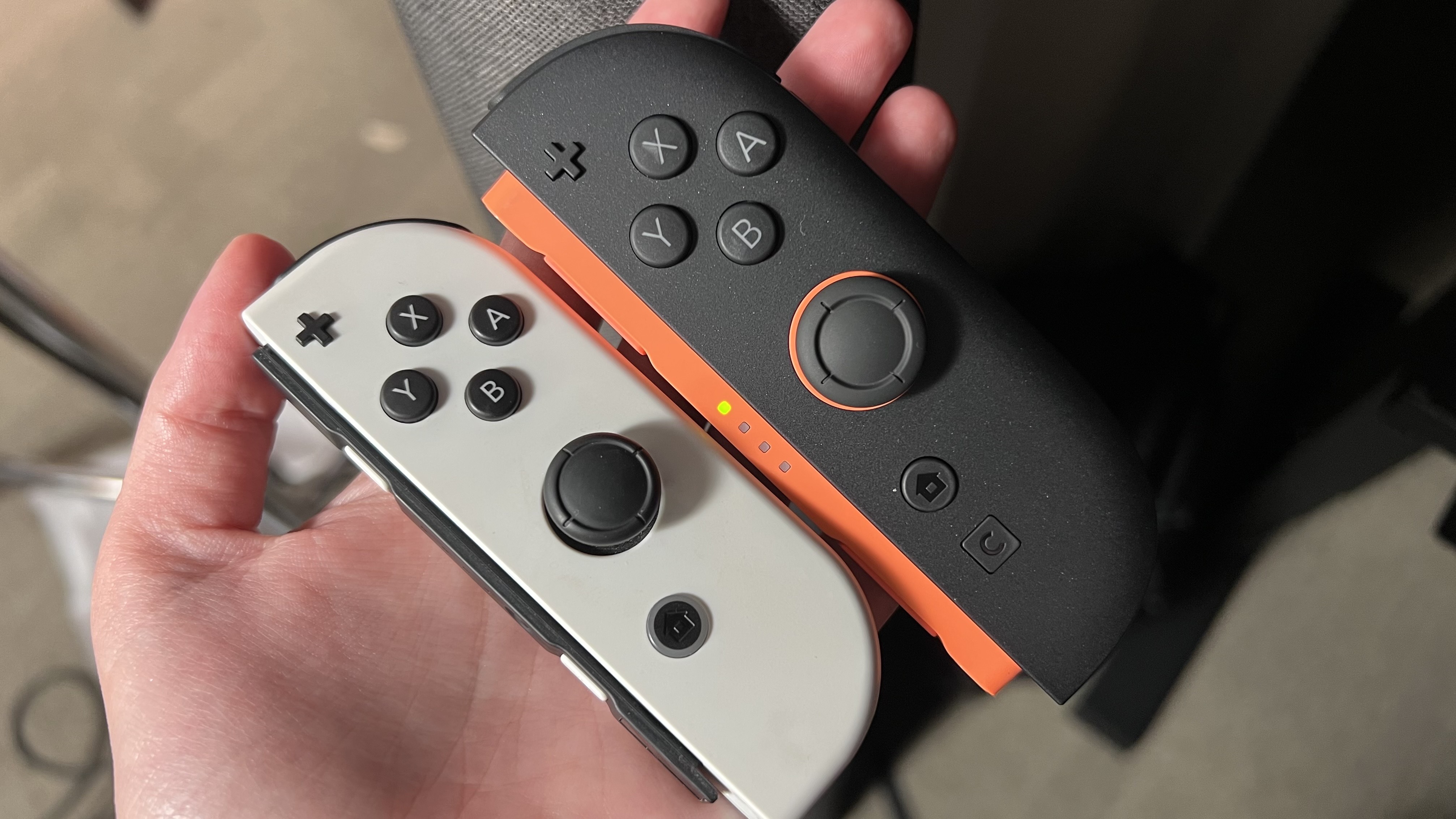 Nintendo Switch 2 Joy-Con with original Nintendo Switch OLED Joy-Con in reviewer's hands