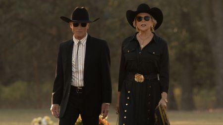 Everett and Beulah walk through a graveyard in funeral attire