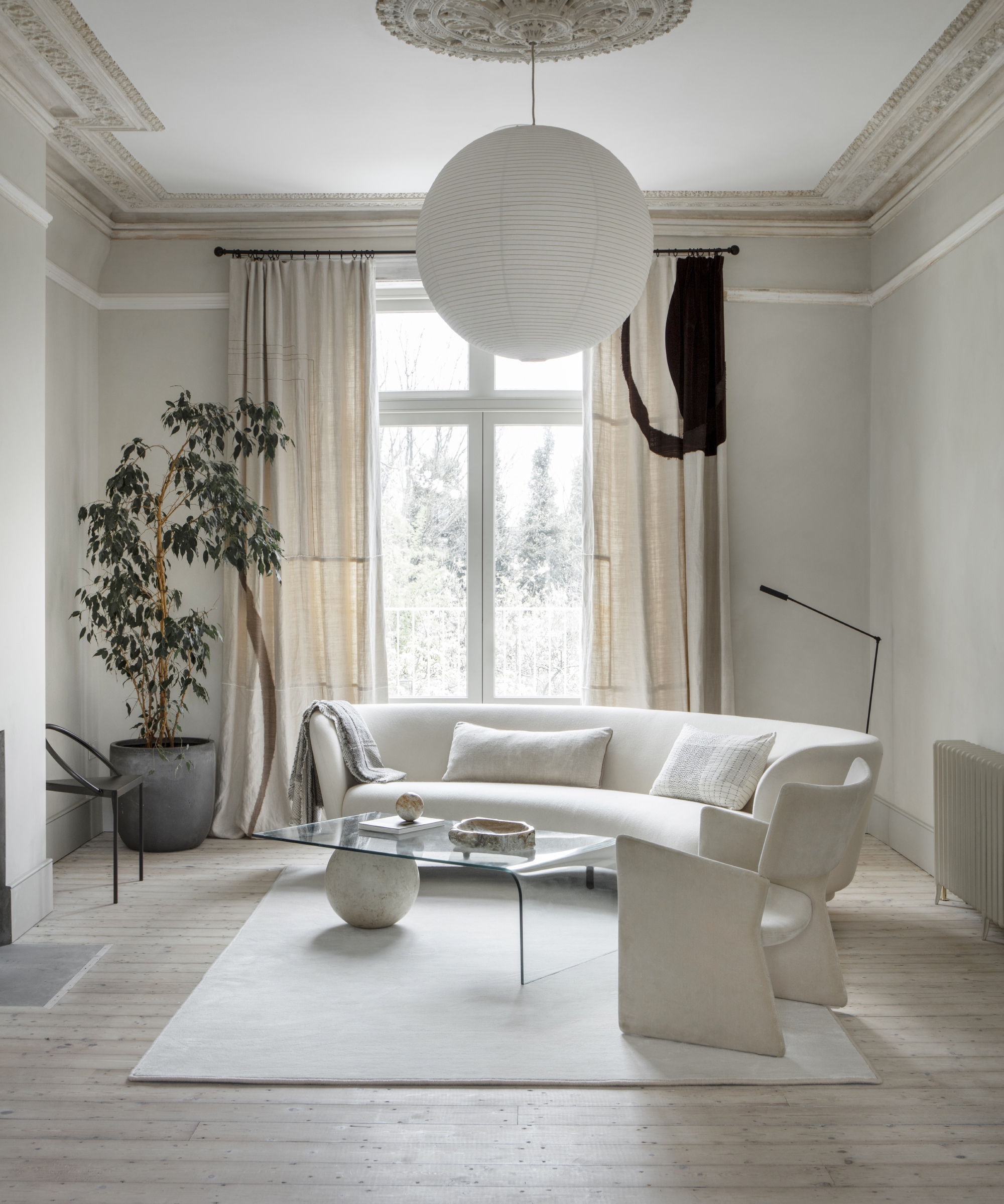 white living room with curved white sofa
