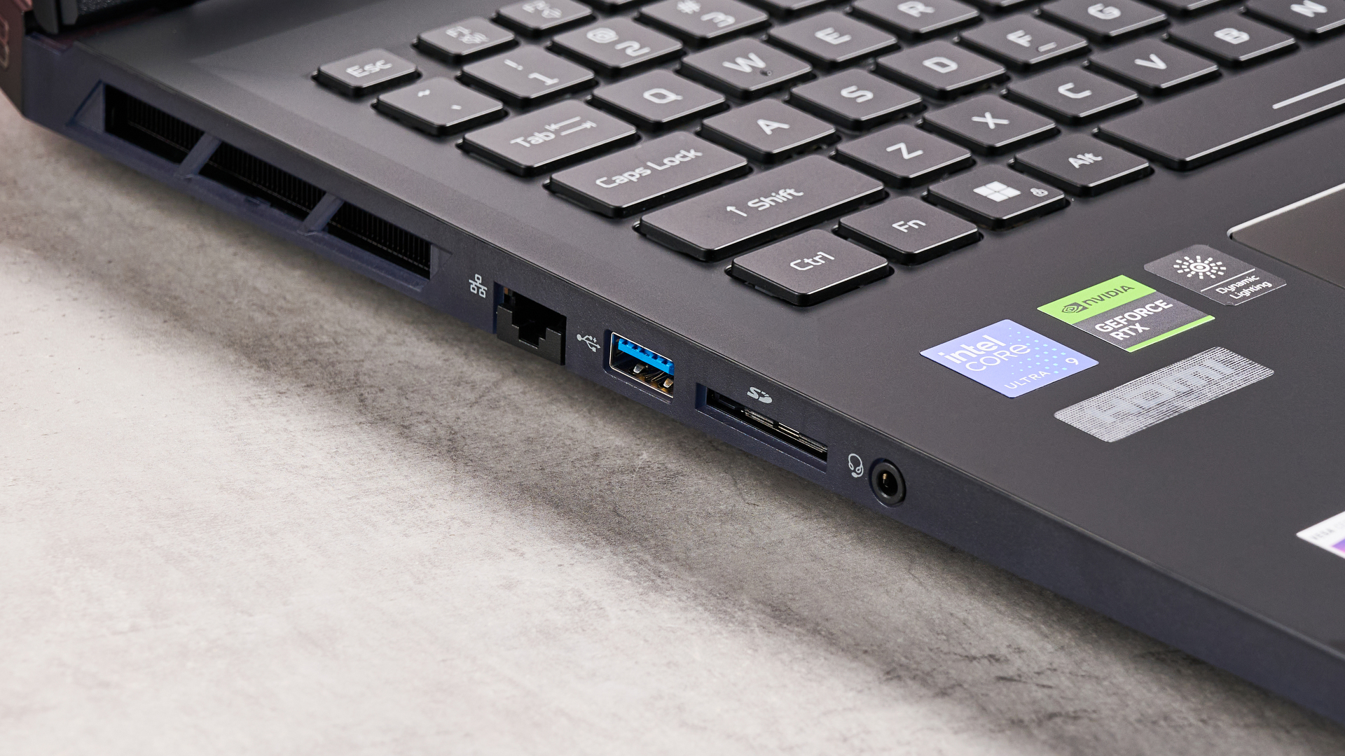 Close-up of left side ports on Acer Predator Helios 18 AI open on desk