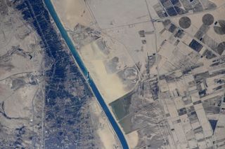 Russian cosmonaut Sergey Kud-Sverchkov shared images taken from the International Space Station of the Ever Given cargo ship stuck askew in the Suez Canal on March 27, 2021.