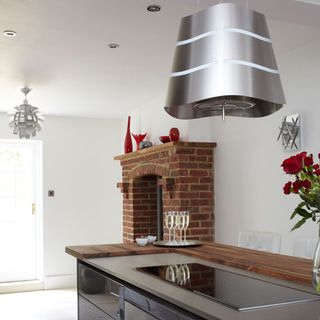 kitchen with bricked fireplace and kitchen worktop