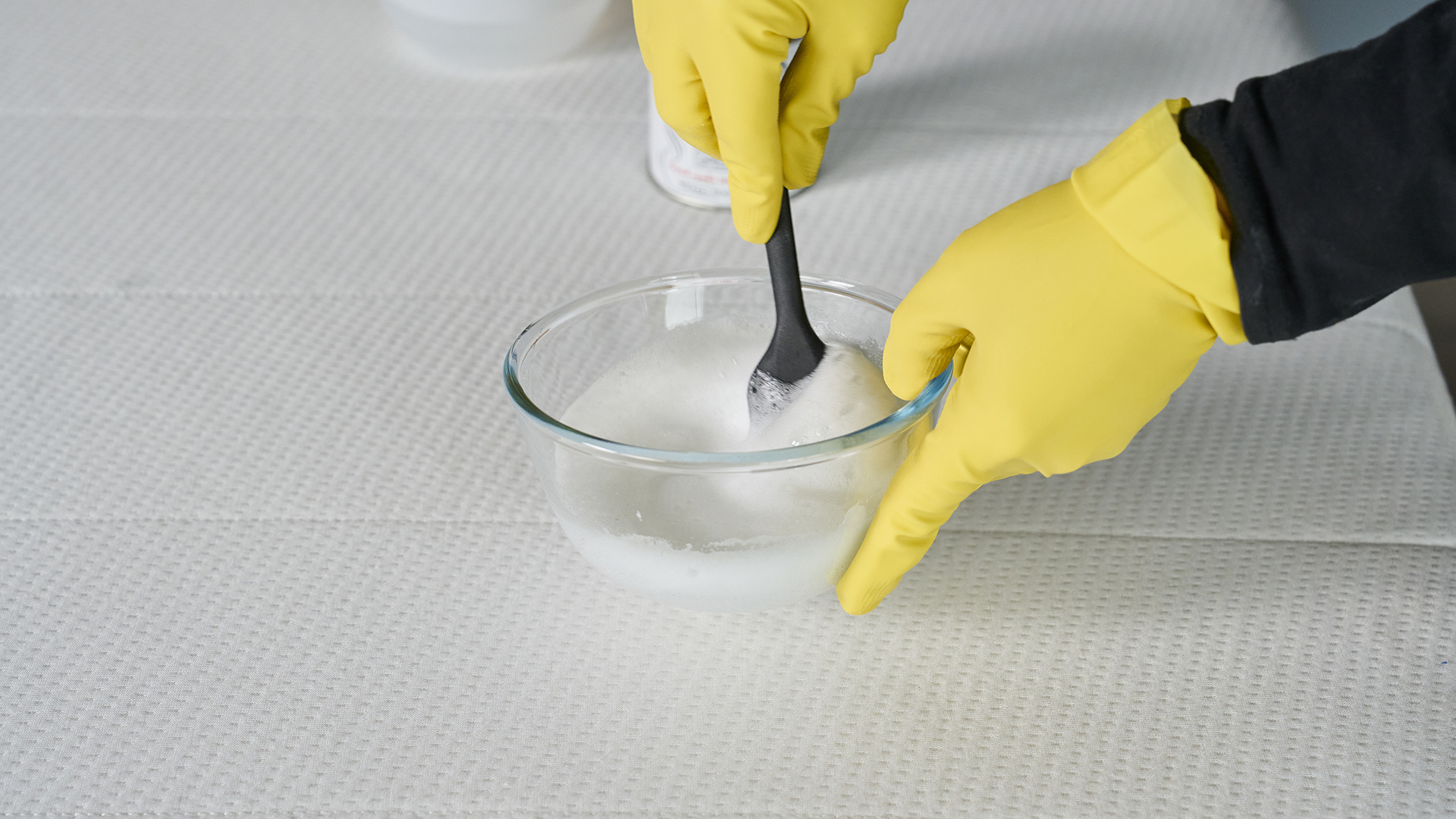A woman mixing a bubbling mattress cleaning solution