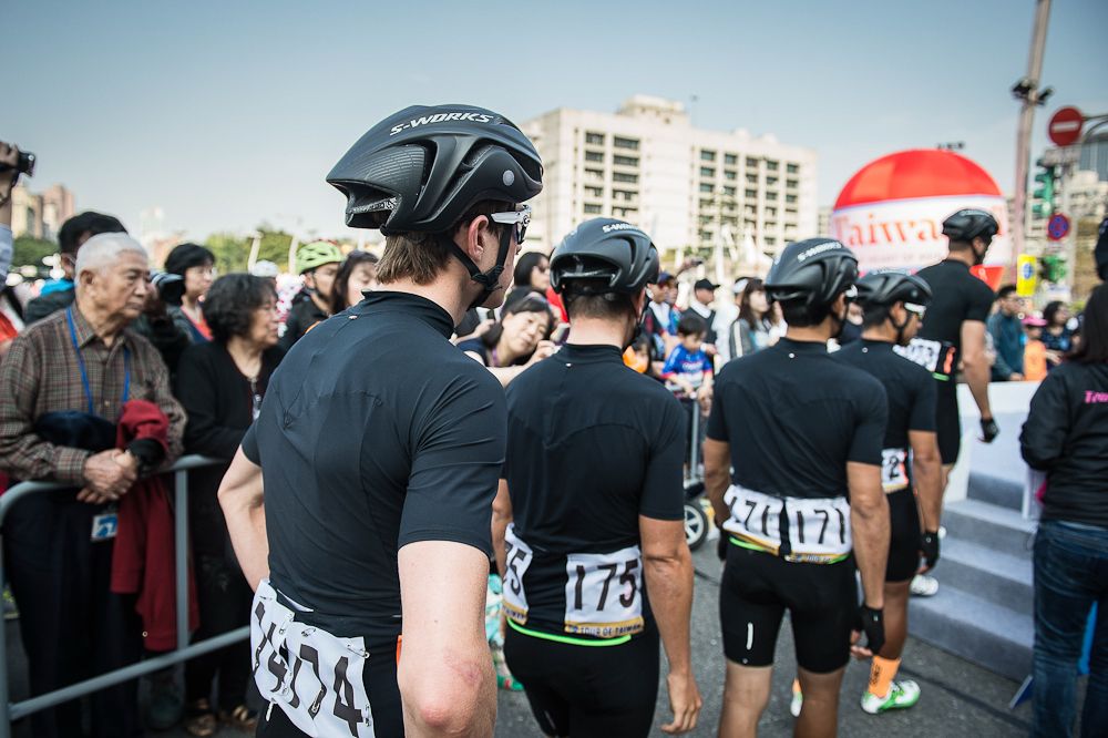 Team Illuminate lines up for signing before a stage start at the Tour de Taiwan.