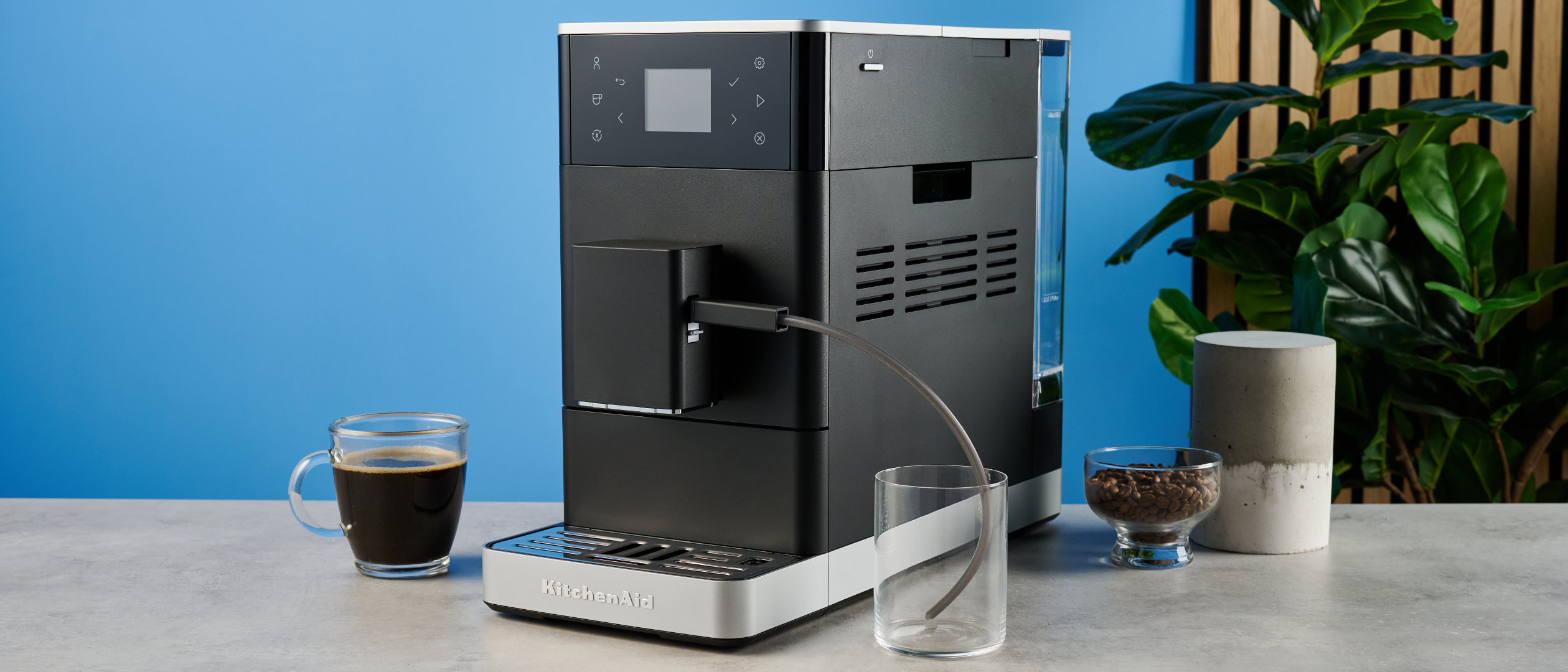 the kitchenaid kf3 superautomatic coffee machine photographed against a blue tom's guide background