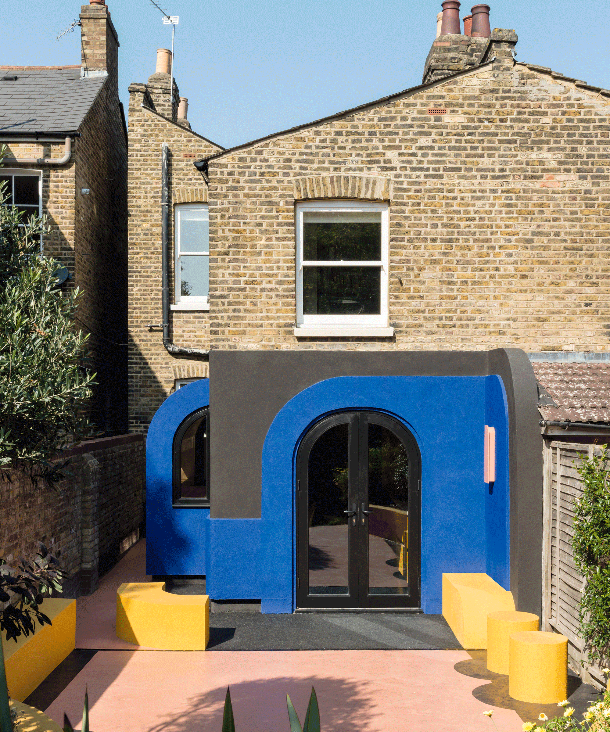 Kitchen extension with blue and yellow concrete exterior