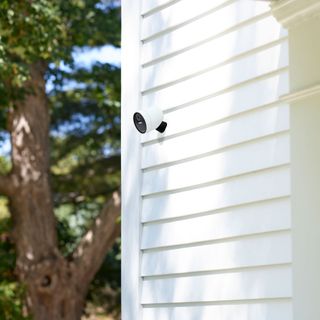 Simplisafe video camera mounted on an exterior wooden clad wall