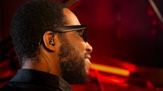 Cory Henry wearing Beyerdynamic's new pro-specific IEMs, sitting at a piano