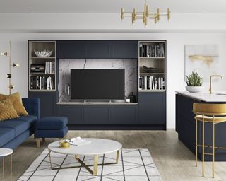 An example of how to plan living room lighting by Benchmarx Kitchens with gold accessories and dark blue sofa and cabinets.