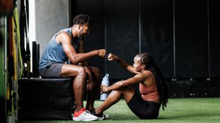 Two friends working out at the gym