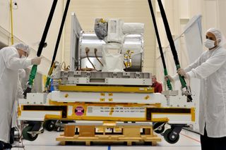 The Optical Payload for Lasercomm Science (OPALS) instrument is hoisted onto a shipping pallet for transfer to Kennedy Space Center in Florida. From there it will launch to the International Space Station.