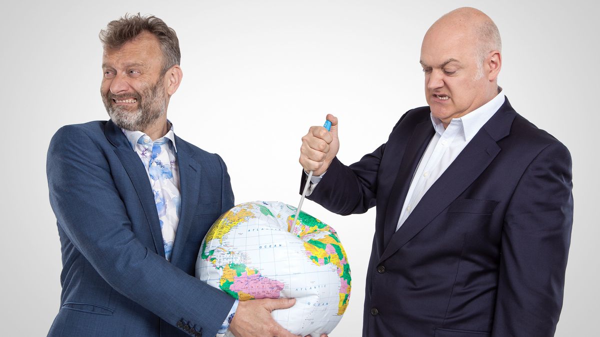 Mock the Week&#039;s Dara O Briain stabs a needle into a blow up globe held by fellow comedian Hugh Dennis.