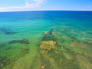 Clear water laps the shore at Pictured Rocks National Lakeshore. Lake Superior has an average underwater visibility of 27 feet (8.2 meters).